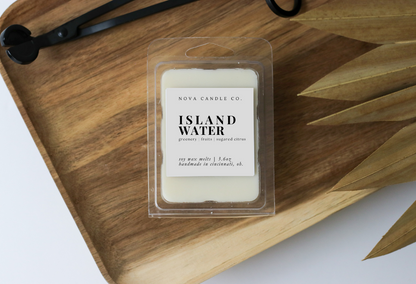 Nova Candle Co. Island Water wax melt on a wooden tray